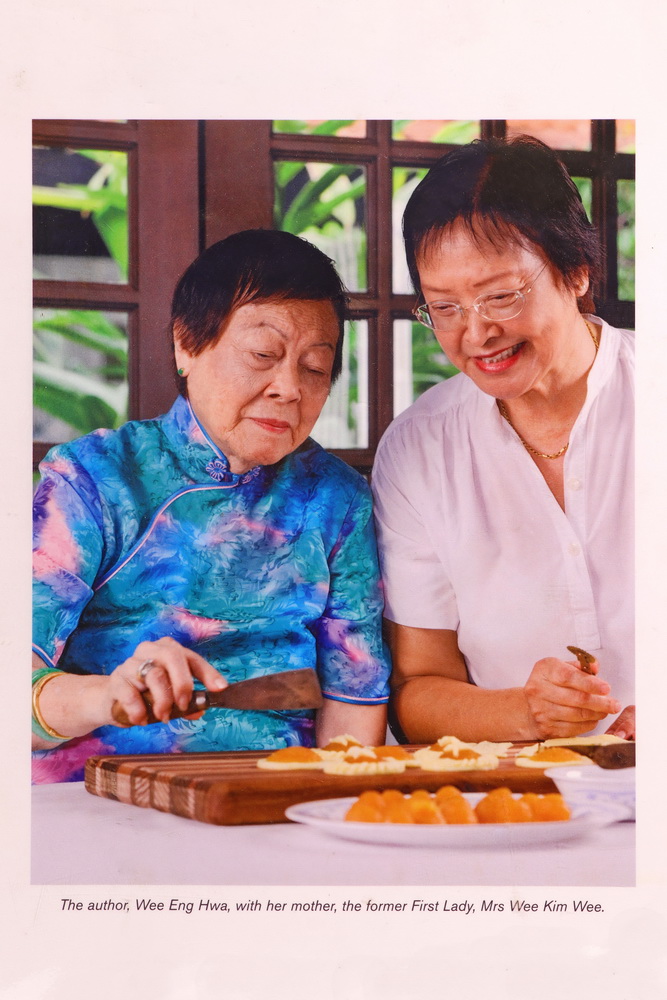 Framed picture of Mrs Wee and daughter Eng Hwa making kueh taa